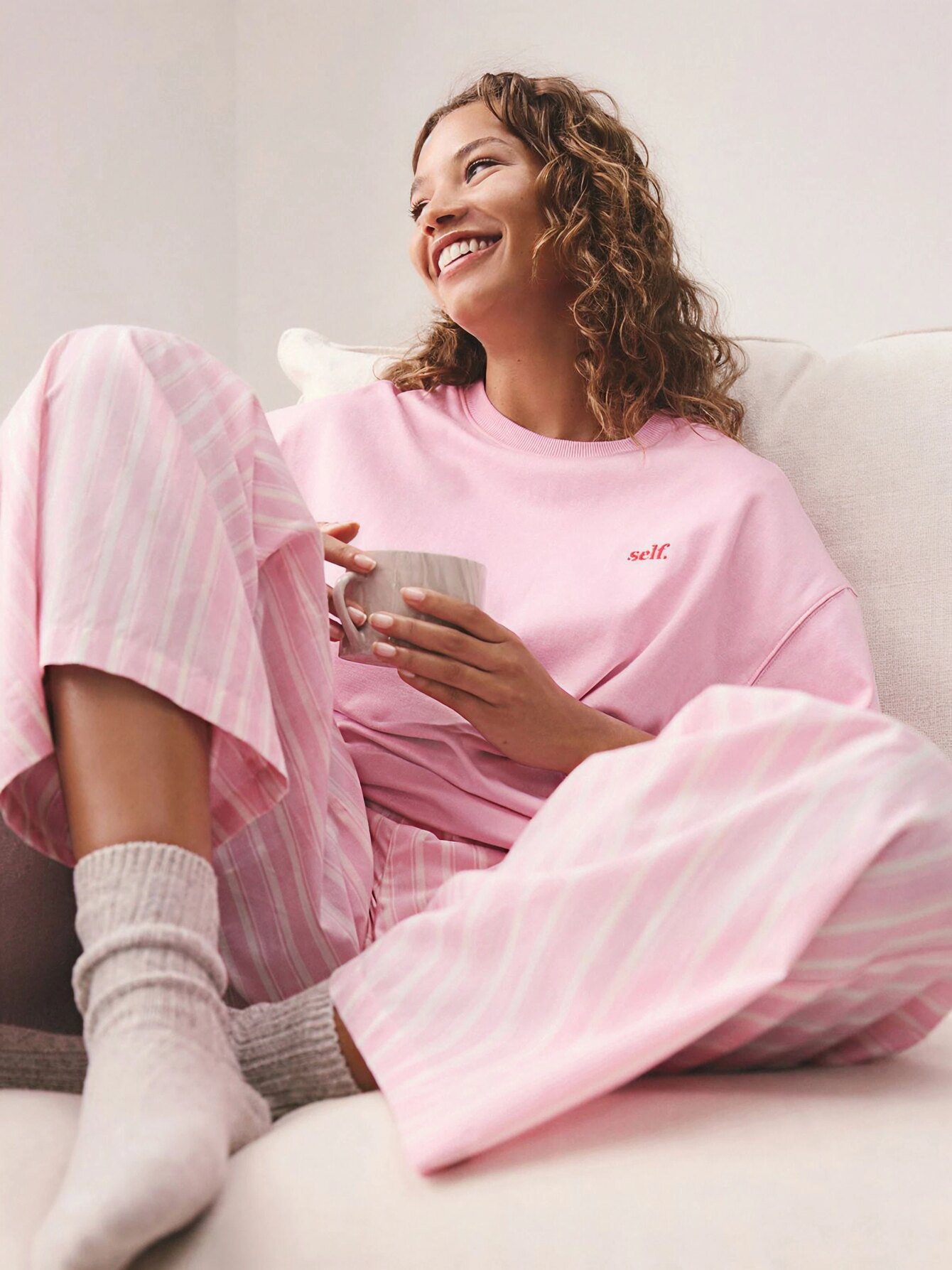 Woman relaxing in soft pink Cloud 9 loungewear